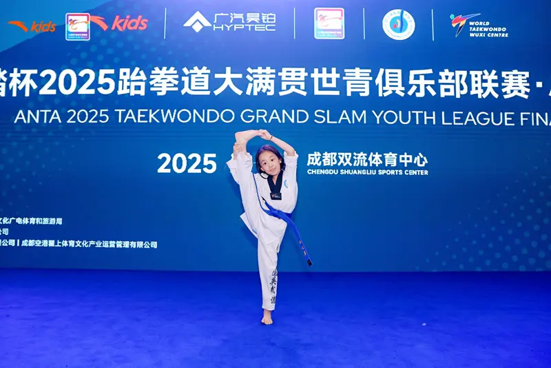 Athlete performing a high kick on stage at the 2025 Grand Slam Youth League